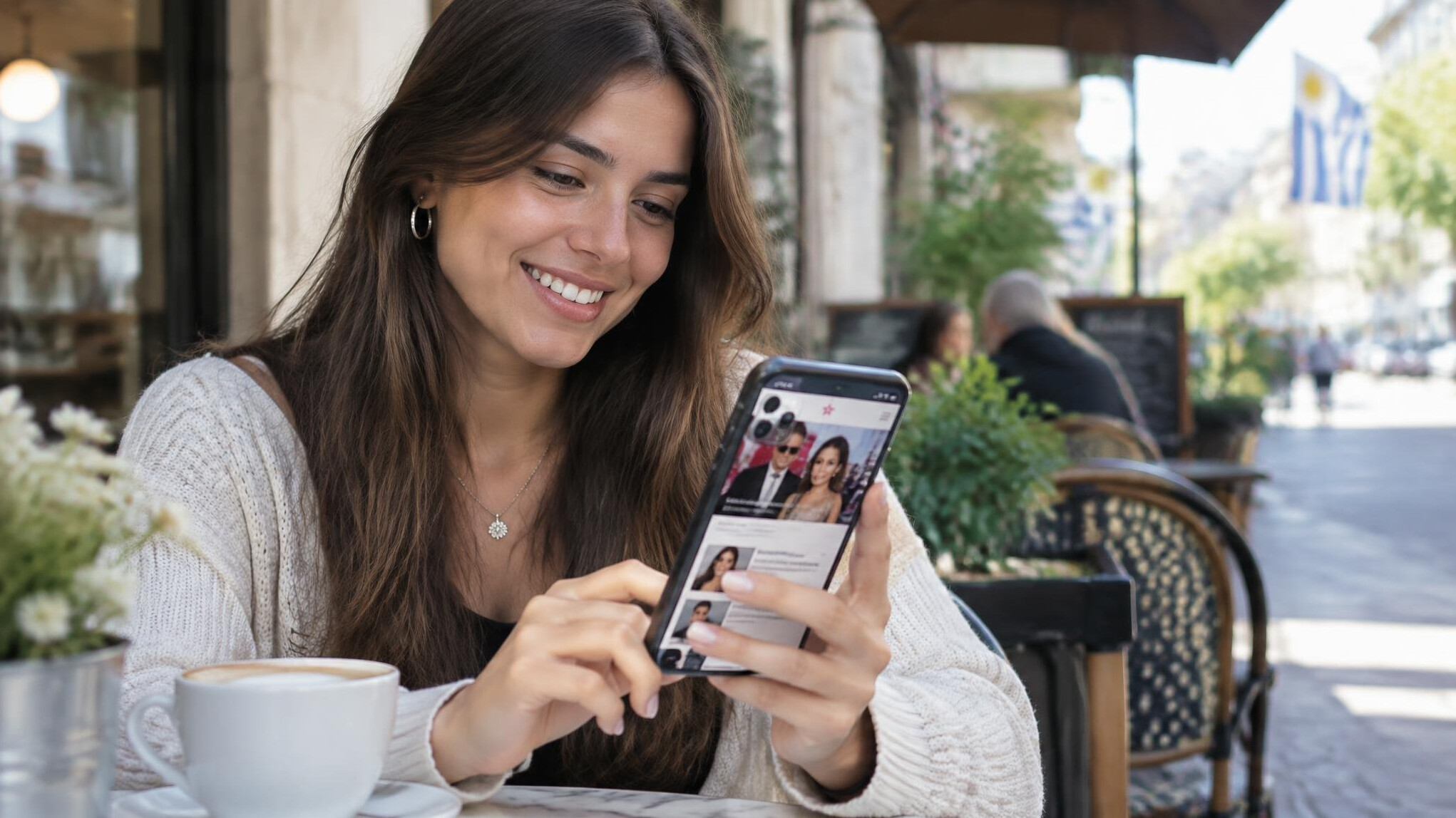 Young Uruguayan woman reading celebrity news on her smartphone